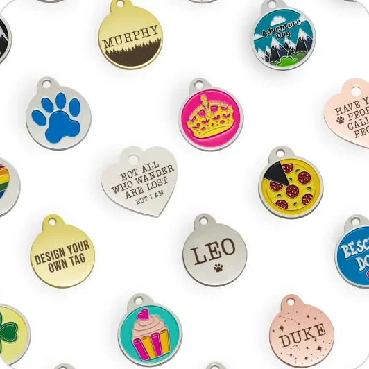 A spread of DocuPet designer tags in different shapes, metals and enamel designs